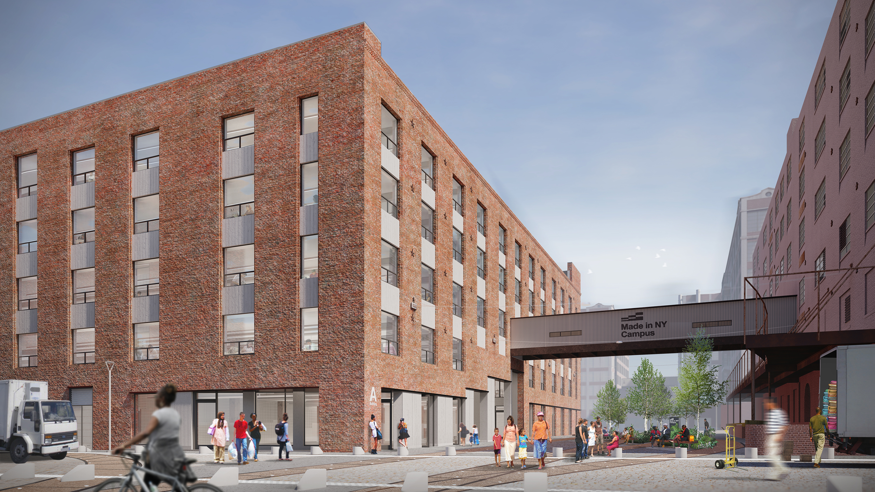 Modern brick building with large windows stands along a New York City street. People walk and gather outside, and a cyclist passes in the foreground. A sign overhead reads, “Made in NY Campus.” Trees and benches line the area.